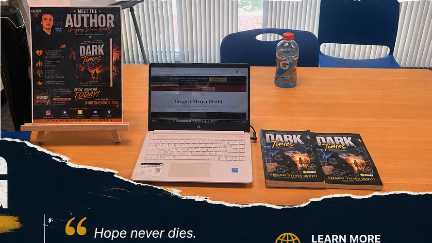 Dark Times table setup with books, laptop, and promotional materials